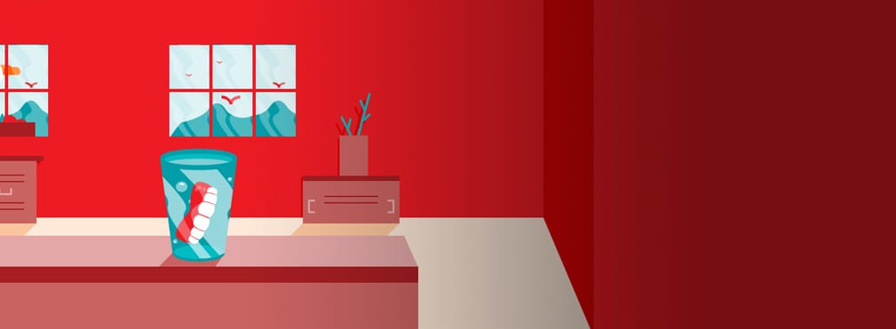 dentures in glass on table