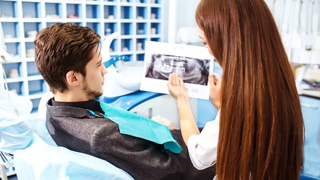 Overview of dental caries prevention man at the dentist's chair during a dental procedure